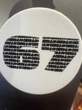 Circular white object with black text pattern on a gray background