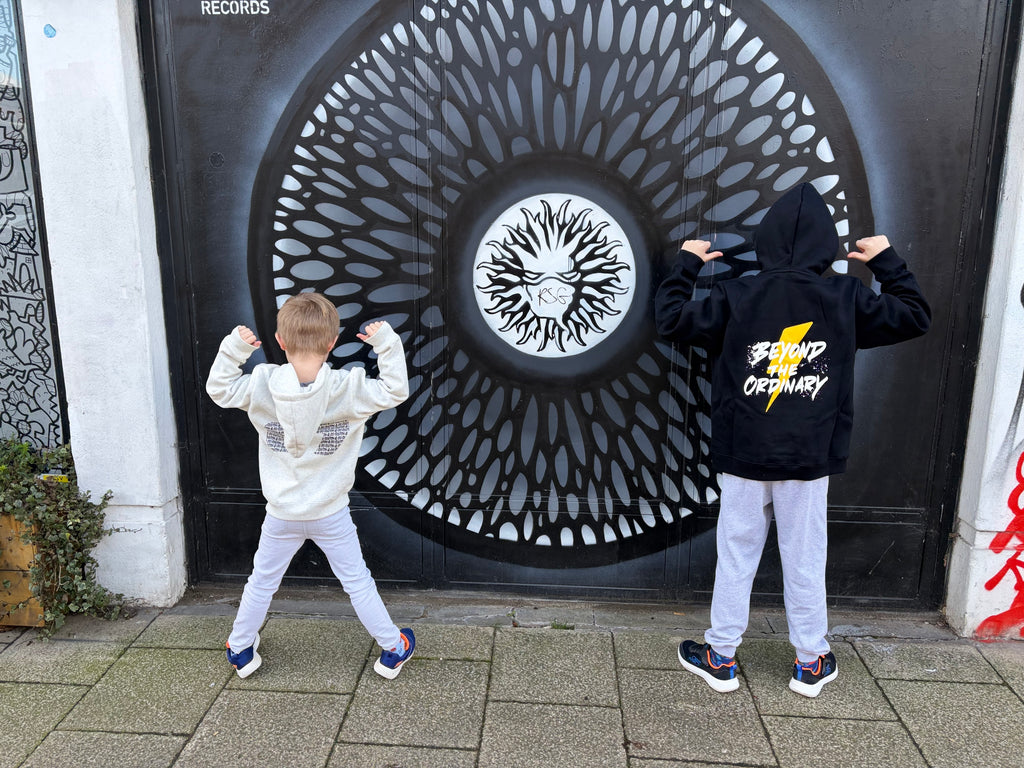 Two children in front of a decorative door with intricate patterns.